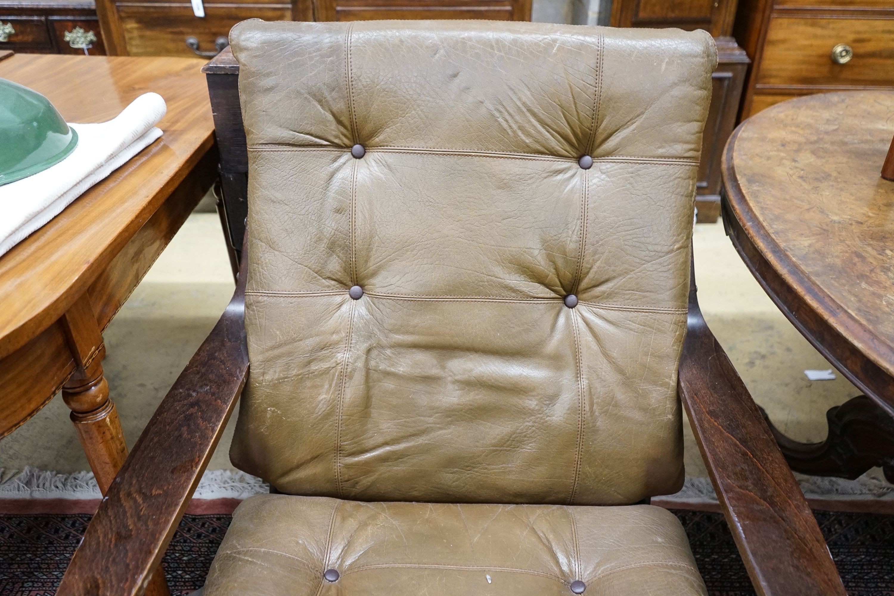 A mid century swivel chair with leather cushion upholstery, width 77cm, depth 75cm, height 94cm